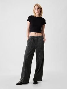 Fit: A full-length high rise jean that's loose throughout.  Finishes with a relaxed wide leg.  Fabric: 95% Cotton, 5% Recycled Cotton.  Stretch: No Stretch Jeans.  Authentic denim that gets better with every wear.  Made to wear all day & break in over time. ​ Rise: High Rise Skirt.  Look: A loose wide-leg utility jean in a black wash.  Details: Elasticized waist, front slant pockets, side cargo pockets, & back patch pockets.  Responsibly Made: This pair of jeans is part of our water-saving Washwell program.  Compared with conventional wash methods, Washwell uses at least 20% less water and has saved over a billion liters of water since 2016.  Our High Rise Jean has an 11" 28 cm) rise. ​ Loose through the hip & thigh.  Relaxed, wide leg.  Full-length jean.  Hits below the ankle.  Models wea Wide Leg Cargo Pants For Elevated Casual Spring Wear, Spring Wide Leg Cargo Pants For Elevated Casual, High Rise Utility Wide Leg Pants For Fall, High Rise Cotton Wide Leg Pants For Elevated Casual, Fall Utility High Rise Wide Leg Pants, High Rise Washed Black Bottoms For Everyday, Utility Wide Leg Bottoms With Relaxed Fit, Relaxed Fit Versatile Flare Jeans With Pockets, Versatile Relaxed Fit Flare Jeans With Pockets