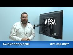 a man is standing in front of a tv with the words vesa on it