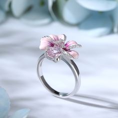 Turn up the flower power with this pink flower ring. Crafted in sterling silver, features every petals hand-painted in rich enamel, decorated with white stones, making every flower completely unique. An organically shaped band mimics a real stem and evokes the freedom of spring. Wear yours as a reminder of all the loved ones in your life.Carat Weight: 2.31 ctStone Shape: Oval, RoundStone Size: 6*8,1,1.2 mmNumber of Stones: 30 Stone Color: Diamond WhiteWeight: 4.3 gWidth: 2.4 mmHeight: 9 mmThickn Pink Silver Jewelry, Pretty Rings Silver, Bunny Ring, Pink Flower Ring, Dreamy Garden, Beautiful Wedding Rings, White Stones, Spring Wear, Pretty Rings