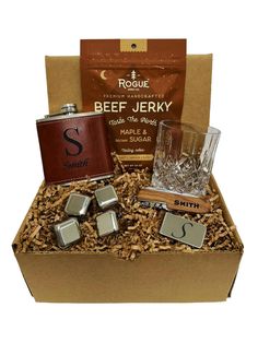 a gift box with liquor, flasks and other personalized items in it