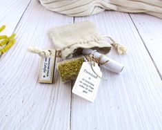 a small bag with some stuff in it on a white wooden floor next to flowers