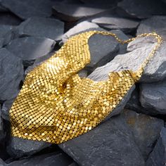 This fantastically stylish Italian necklace features gold mesh, which falls along the neckline in a triangular shape. It folds and ripples softly and beautofully, almost emulating fabric. It is crafted in solid 14k yellow gold and hangs 17 inches in length. It is finished with a lobster claw clasp. Luxury Gold Necklaces For Party, Luxury Gold Necklace For Parties, Elegant Gold Triangle Necklace, Elegant Gold Bib Necklace For Evening, Elegant Chainmail Necklaces For Party, Elegant Chainmail Necklace For Party, Elegant Gold Bib Necklace As A Gift, Italian Necklace, Lobster Claw