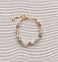 Pearl bracelet Freshwater pearl jewelry Rainbow, soft bracelet features Baroque pearls Multi-colored natural stone (pink quartz, chalcedony,larimar, kunzite and jade) Gold plated brass clasp Length - 16-22 cm(Adjustable) Pearl and stone vary in size and shape Please contact us for specific questions, size, color, etc. -Care -Delicate Jewelry, Especially Dainty Chain Designs, Should be Treated with Care While Wearing to Prevent Breakage. -Many factors can influence the condition of the jewelry. T Natural Stones Pearl Bracelet As A Gift, Pastel Gemstone Beads Jewelry For Gifts, Dainty Pearl Bracelet With Natural Stones As Gift, Dainty Pearl Bracelet With Natural Stones, Dainty Natural Stone Pearl Bracelet Gift, Pearl Bracelet With Natural Round Beads, Natural Stone Pearl Bracelet With Round Beads, Handmade Pastel Bracelets For Gift, Pearl Beaded Gemstone Bracelets As Gift