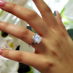 a woman's hand with a diamond ring on it