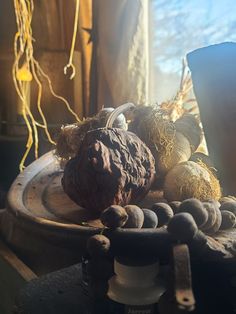 an assortment of nuts and other things on a plate in front of a window with sunlight coming through