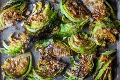 cooked brussel sprouts on a baking sheet with seasoning and spices