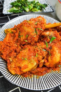 a white plate topped with meat covered in sauce