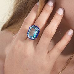 JR0365-BT 'Mélange' Blue Topaz with Lapis Lazuli & Turquoise Inlay Emerald Cut Ring in 18K Gold Stone Size: 19.2 x 14.2 mm Approx. Stone Wt: 21.16 Carats (Blue Topaz) Luxury Emerald-cut Topaz Ring, Yellow Gold Emerald-cut Blue Topaz Ring, Blue Emerald-cut Ring In Fine Jewelry Style, Classic Blue Emerald-cut Topaz Ring, Blue Emerald-cut Topaz Ring In 14k Gold, Lapis Lazuli Ring, Emerald Cut Rings, Pendant Rings, Emerald Cut