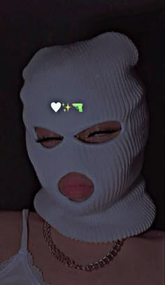 a woman wearing a white face mask in the dark