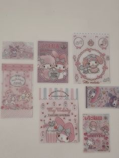 hello kitty greeting cards and envelopes are arranged on a white surface with pink accents