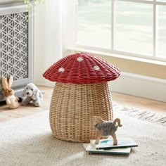 a wicker basket with an animal figurine in front of it on the floor