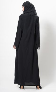 Featuring a flared muslimah abaya dress in nida fabric adorned with self color floral lace panels on the centre front and loose elongated sleeves. It has an easy and flowy silhouette perfect to be worn for informal ocassions as an everyday abaya.FIT : Relaxed fit.COMPOSITION : Nida.CARE : Dry clean only. Modest Black Abaya With Long Sleeves, Modest Black Long Sleeve Abaya, Modest Long Sleeve Black Abaya, Black Long Sleeve Hijab For Eid, Modest Black Long Sleeve Khimar, Modest Long Sleeve Black Khimar, Black Khimar For Eid, Black Long Sleeve Khimar For Eid, Long Sleeve Black Khimar For Eid