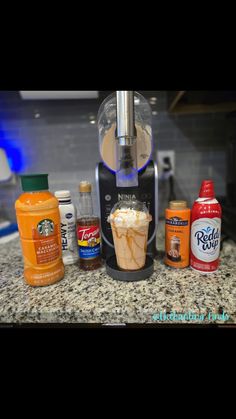 the blender is full of different types of drinks and condiments on the counter