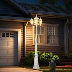 a street light in front of a house at night