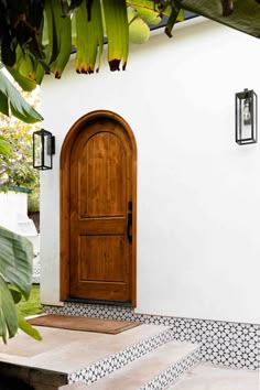 a white house with a wooden door and steps