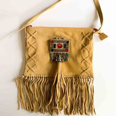 The Suede Festival Fringe Bag Will Go Anywhere You Go! Festivals, Clubs, Parties, And Any Adventure Under The Stars. Pairs Perfectly With Your Boho Style From Dresses To Jeans To Your Favorite Kimono. Embellished With Vintage Adornments, Suede Fringe And Tassel. So Fun! New Without Tags Suede Lined Inside Zipper Closure With Suede Pull One Zipper Pocket Inside 10" Wide X 7 3/4" Tall 6" Fringe 22 1/2" Strap Drop Length Bohemian Pouch Bag With Detachable Strap, Bohemian Pouch Shoulder Bag With Detachable Strap, Bohemian Beige Pouch Bag, Camel Rectangular Shoulder Bag With Detachable Strap, Bohemian Tote Bags With Detachable Strap, Bohemian Clutch Bag For Daily Use, Bohemian Beige Bag With Removable Pouch, Camel Shoulder Bag With Detachable Strap, Bohemian Bag With Detachable Strap For Daily Use