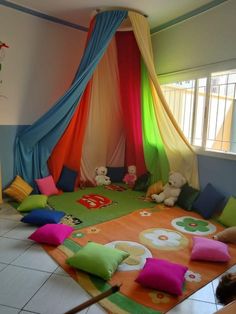 a child's play room with colorful curtains and stuffed animals on the rugs