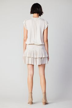 Done in a soft ecru shade, this short-sleeve mini dress ties up at the neckline and cinches in at the waist before falling to a thigh-skimming tiered hem with crisp, raw edges. The perfect one-and-done number for date night - not to mention one of Current Air's most popular dress. •V-neckline with tie •Relaxed fit •Ruffle trim •Pleated cap sleeves •Elasticized waist •Tiered pleated skirt •Raw edges Item number 1990061-1 100% Polyester Dry clean Imported Popular Dress, Popular Dresses, Short Sleeve Mini Dress, Skirt Mini, Tie Dress, Mini Dress With Sleeves, Trending Dresses, Ruffle Trim, Item Number