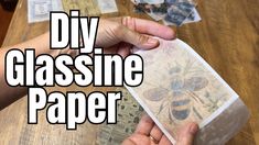 a person holding a piece of paper with the words diy glassine paper on it