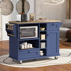 a blue kitchen island with a microwave on it's top and shelves underneath the cabinet