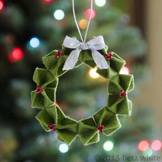 a christmas wreath ornament hanging from a tree