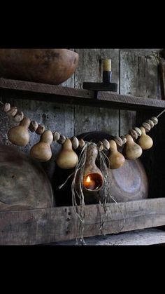 an old wooden shelf with some kind of decoration on it's sides and lights in the middle