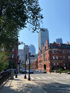 an empty city street with tall buildings in the background