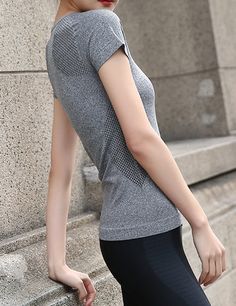 Stretchy, soft sport workout top. Large fits as a medium 92% Nylon, 8% Spandex Stretch Moisture-wicking Activewear For Light Sports, Versatile Stretch Gray Activewear, Versatile Gray Stretch Activewear, Gray Seamless Nylon Activewear, Casual High Stretch Activewear With Light Support, Casual Activewear With Light Support And High Stretch, Stretch Activewear With Seamless Construction, Seamless Stretch Activewear For Sports Season, Casual Sports T-shirt With Snug Fit