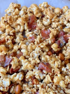 a mixture of nuts and bacon on top of parchment paper, ready to be eaten