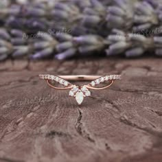 a rose gold ring with pear shaped diamonds