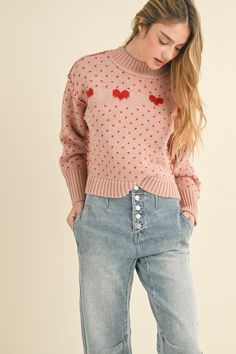 Pink long sleeve knit sweater with red heart details. Model is wearing a small. Height - 5' 9" / 179.8CM Love Sweater, Zippered Sweater, Long Sleeve Knit Sweaters, Jumpsuit Shorts Rompers, Pink Long Sleeve, Pattern Sweater, Crop Top Blouse, Heart Pattern, Denim Flares