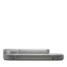 a gray couch sitting on top of a white floor