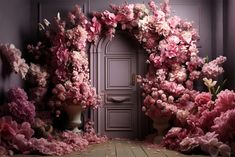 a doorway is surrounded by pink flowers on the floor