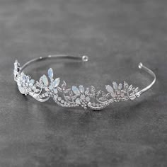 a tiara with crystal flowers and leaves on the headband is seen in this image