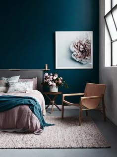 a bedroom with blue walls and white carpet