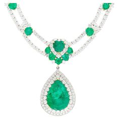 45.58 Carat total chandelier drop necklace in 18k white gold. Featuring a GRS certified 18.82 carat Colombian emerald center stone with adorning heart cut emeralds and diamonds. Fixed on a tennis necklace chain that echoes a symbol of sophistication and luxury. A noticeably valuable piece fitting for the neck of a red carpet celebrity. Details:  ✔ Item type: Necklace ✔ Design: Chandelier ✔ Metal: 18k white and yellow gold ✔ Weight: 40.24 grams ✔ Setting: Prong, Halo ✔ Closure: Box ✔ Length: 18 Inches Center Stone Details: ✔ Gemstone: Emerald ✔ Carat: 18.82 CTTW ✔ Color: Green ✔ Cut: Pear ✔ Origin: Colombia ✔ Treatment: Minor-Moderate ✔ Measurements: 21.65 x 15.48 x 12.01 mm  GRS Certified Side Stone Details (2): ✔ Gemstone: Emerald ✔ Carat: 1.99 CTTW ✔ Color: Green ✔ Cut: Heart Side Stone Bridal Diamond Necklace, Diamond Chandelier, Colombian Emeralds, Baguette Cut Diamond, Tennis Necklace, Emerald Jewelry, Gorgeous Jewelry, Dream Jewelry, Drop Necklace