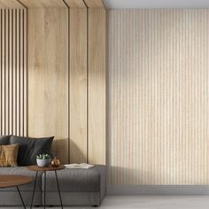 a living room with wood paneling on the walls and a gray couch next to a coffee table