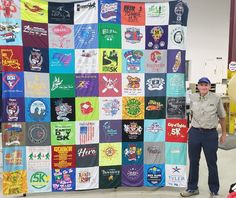 a man standing in front of a large quilt