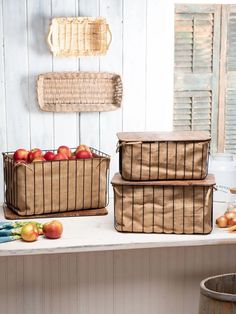 three baskets filled with apples sitting on top of a counter next to an apple basket