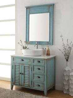 a bathroom with a sink, mirror and vases on the floor in front of it