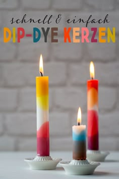 three colorful candles sitting on top of each other with the words diy kerzen over them