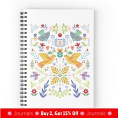 a spiral notebook with birds and flowers on it