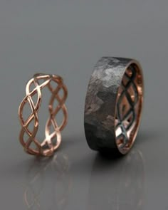 two wedding rings made out of copper and black wood, one with an intricate design