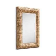 a mirror that is made out of wicker and has a wooden frame on the wall