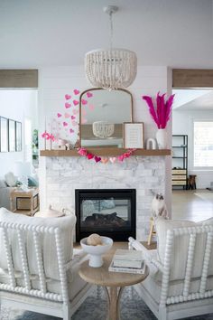 a living room filled with furniture and a fire place in front of a white fireplace