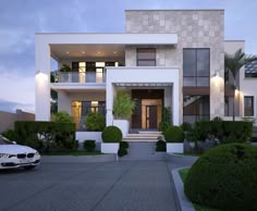 a car is parked in front of a modern house