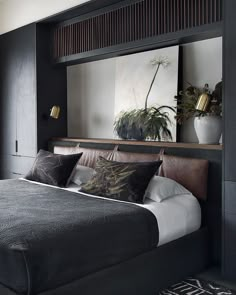 a large bed sitting under a mirror in a bedroom