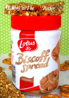 a jar of biscuit spread next to some pretzels