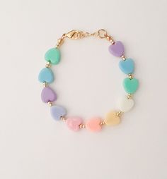 "If you would like to add gold filled hardware to a bracelet, please use this link to purchase it along with the bracelet. You will need to purchase one for EACH bracelet you would like to add gold filled hardware to. https://www.etsy.com/LittleLovliesShop/listing/860546443/gold-filled-upgrade?utm_source=Copy&utm_medium=ListingManager&utm_campaign=Share&utm_term=so.lmsm&share_time=1598757365437 Rainbow Heart Bracelet. These colorful pastel beads are aligned in a rainbow pattern a Playful Heart-shaped Gold Jewelry, Cute Adjustable Jewelry For Valentine's Day, Adjustable Pastel Stretch Bracelet As Gift, Adjustable Pastel Stretch Bracelet For Gift, Multicolor Gold Bracelet For Gift, Handmade Pastel Bracelets For Gift, Mother's Day Heart Beads Bracelets, Cute Heart-shaped Friendship Jewelry, Mother's Day Everyday Heart Bead Bracelets