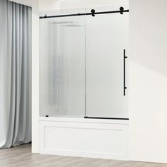 an empty room with a sliding glass shower door